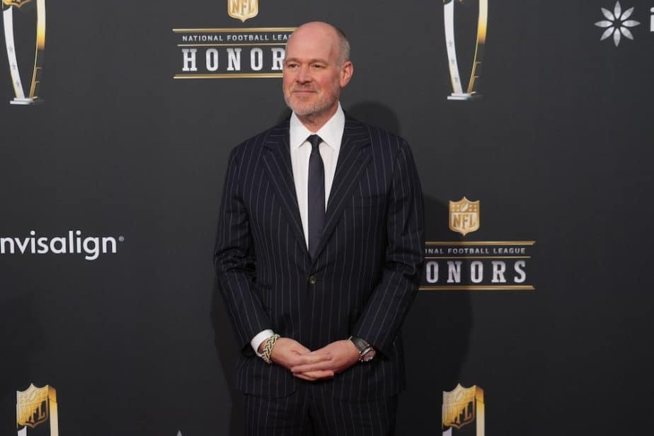 Rich Eisen on the red carpet before the NFL Honors holds his hands.