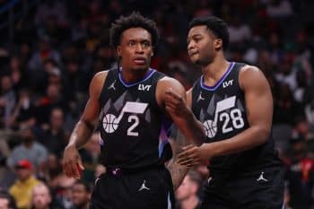 Utah Jazz guard Collin Sexton stands with a teammate.