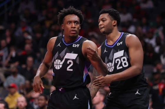 Utah Jazz guard Collin Sexton stands with a teammate.