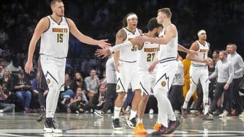 nuggets-center-nikola-jokic-point-guard-jamal-murray-and-guard-christian-braun-celebrate-a-play-on-the-court-against-the-nets-during-overtime-at-barclays-center-ezgif.com-resize