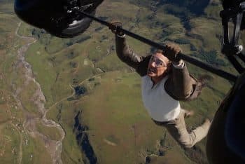 Tom Cruise holds onto a helicopter in mid-air.