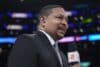 ESPN analyst Mark Jackson holds a mic.