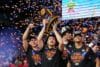 Florida Gators hold up the trophy.