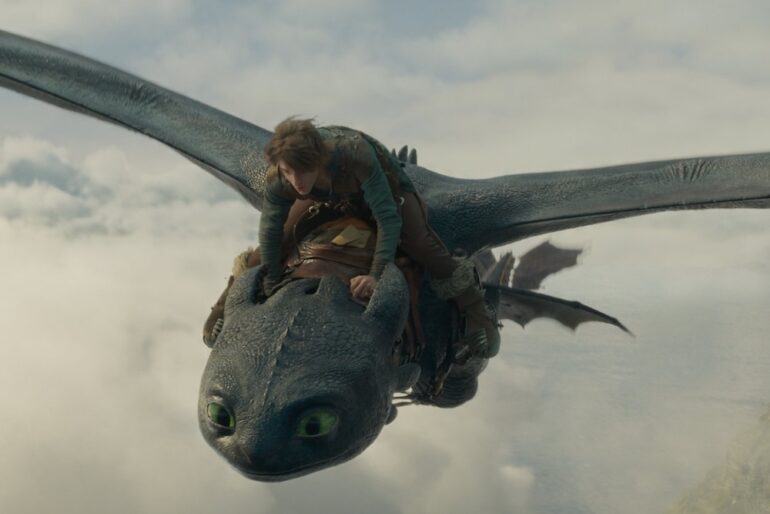 A boy rides a creature in How to Train Your Dragon.