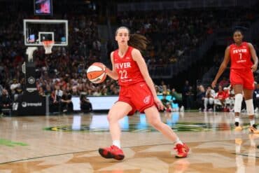 Caitlin Clark dribbles the basketball.