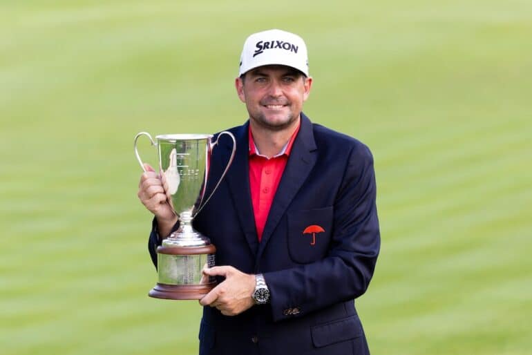 Keegan Bradley holds a trophy.