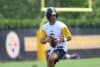 Aaron Rodgers holds the ball and readies to throw.
