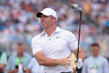 Rory McIlroy swings a club.