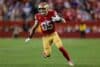 George Kittle runs with the ball.
