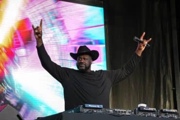 Shaquille O'Neal puts his hands up.