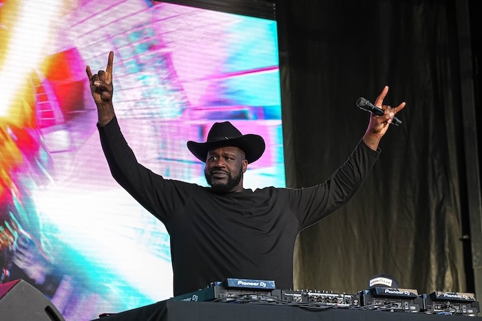 Shaquille O'Neal puts his hands up.