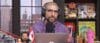 Ariel Helwani sits behind his mic.
