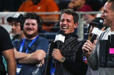 Comedian Tony Hinchcliffe holds a microphone.