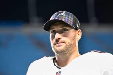 Atlanta Falcons quarterback Kirk Cousins looks in the distance.