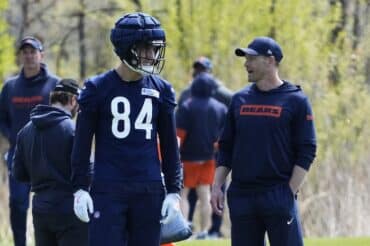 Chicago Bears head coach Ben Johnson stands next to Colston Loveland.