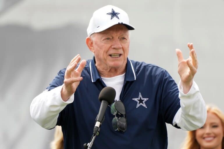Dallas Cowboys owner Jerry Jones holds his hands up.