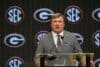 Kirby Smart stands at a podium.