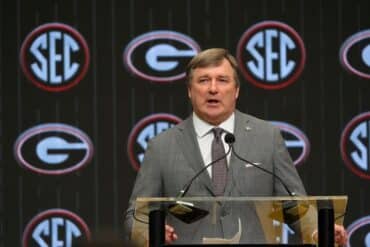 Kirby Smart stands at a podium.