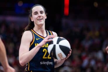 Caitlin Clark holds the basketball.