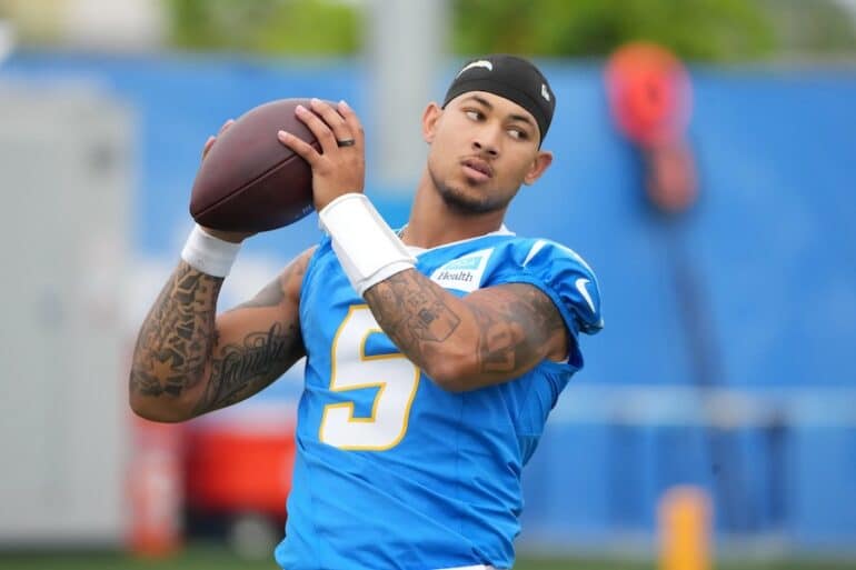 Trey Lance holds the ball up.