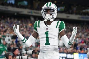 Sauce Gardner holds his hands out.