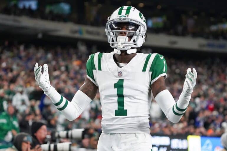 Sauce Gardner holds his hands out.