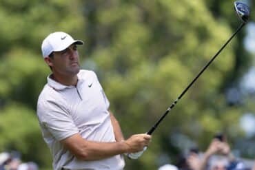 Scottie Scheffler holds a club.