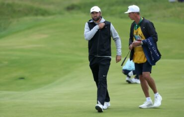 Scottie Scheffler reacts and walks.