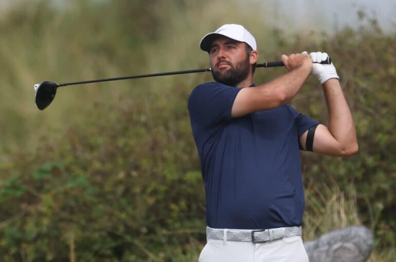 Scottie Scheffler swings a club.