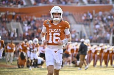 Texas Longhorns quarterback Arch Manning runs on the field.
