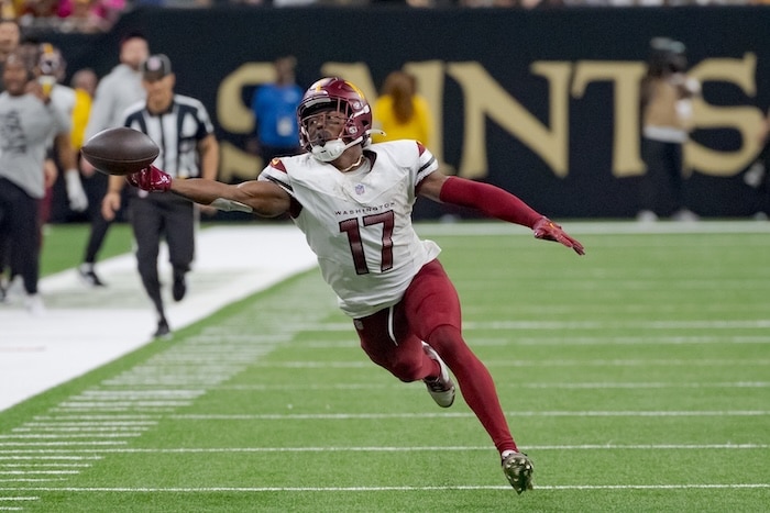 Washington Commanders wide receiver Terry McLaurin reaches for the ball.