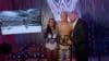 Cody Rhodes stands with Triple H and Brandi.