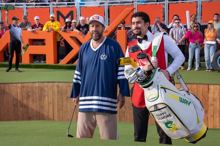 Adam Sandler stands next to Bad Bunny.