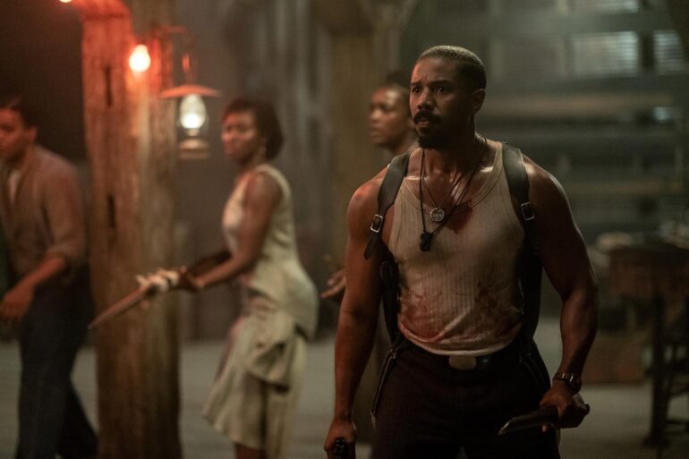 Michael B. Jordan stares at a group.