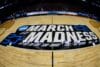 March Madness logo on the court.