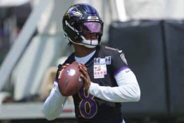 Lamar Jackson holds the ball and prepares to throw.