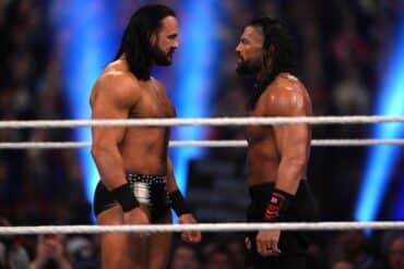 Drew McIntyre and Roman Reigns stand in the ring.