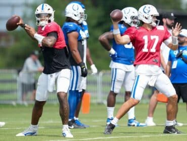 Anthony Richardson and Daniel Jones throw footballs.