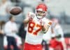 Travis Kelce goes to catch a pass.