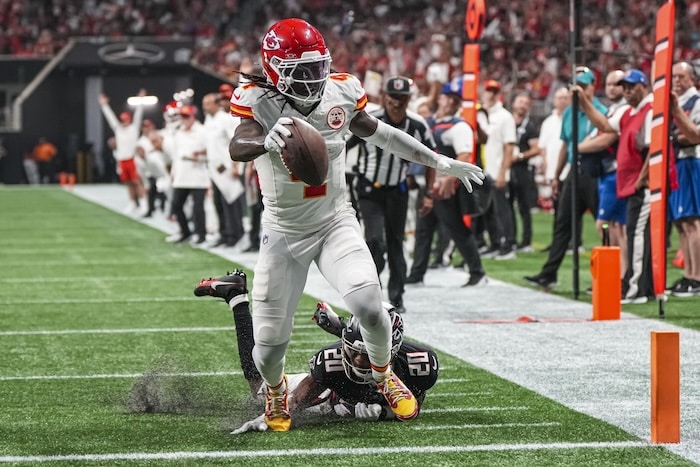 Rashee Rice sticks a football out.