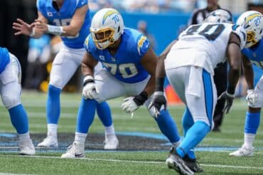 Rashawn Slater lines up to block.