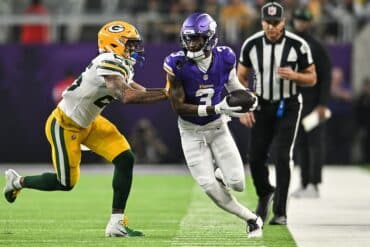 Minnesota Vikings wide receiver Jordan Addison catches and runs the ball.