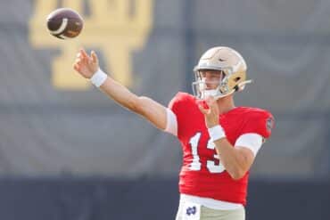 CJ Carr throws a football.
