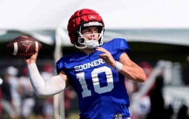 John Mateer holds the ball and prepares to throw.