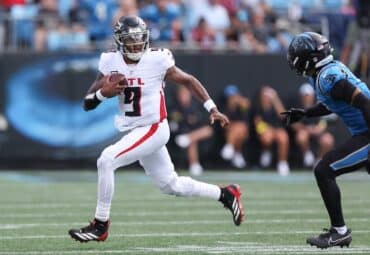 Michael Penix runs with the ball.