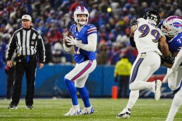 Josh Allen holds the ball and prepares to throw.