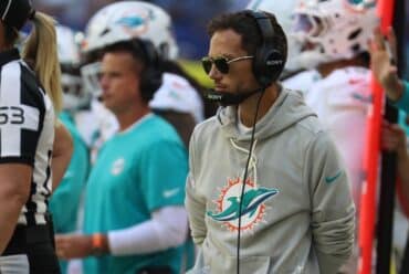 Mike McDaniel stands on the sidelines.