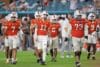 The Miami Hurricanes walk on the field.