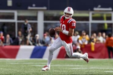 Drake Maye runs the ball.