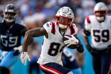 New England Patriots wide receiver Kendrick Bourne holds the ball.